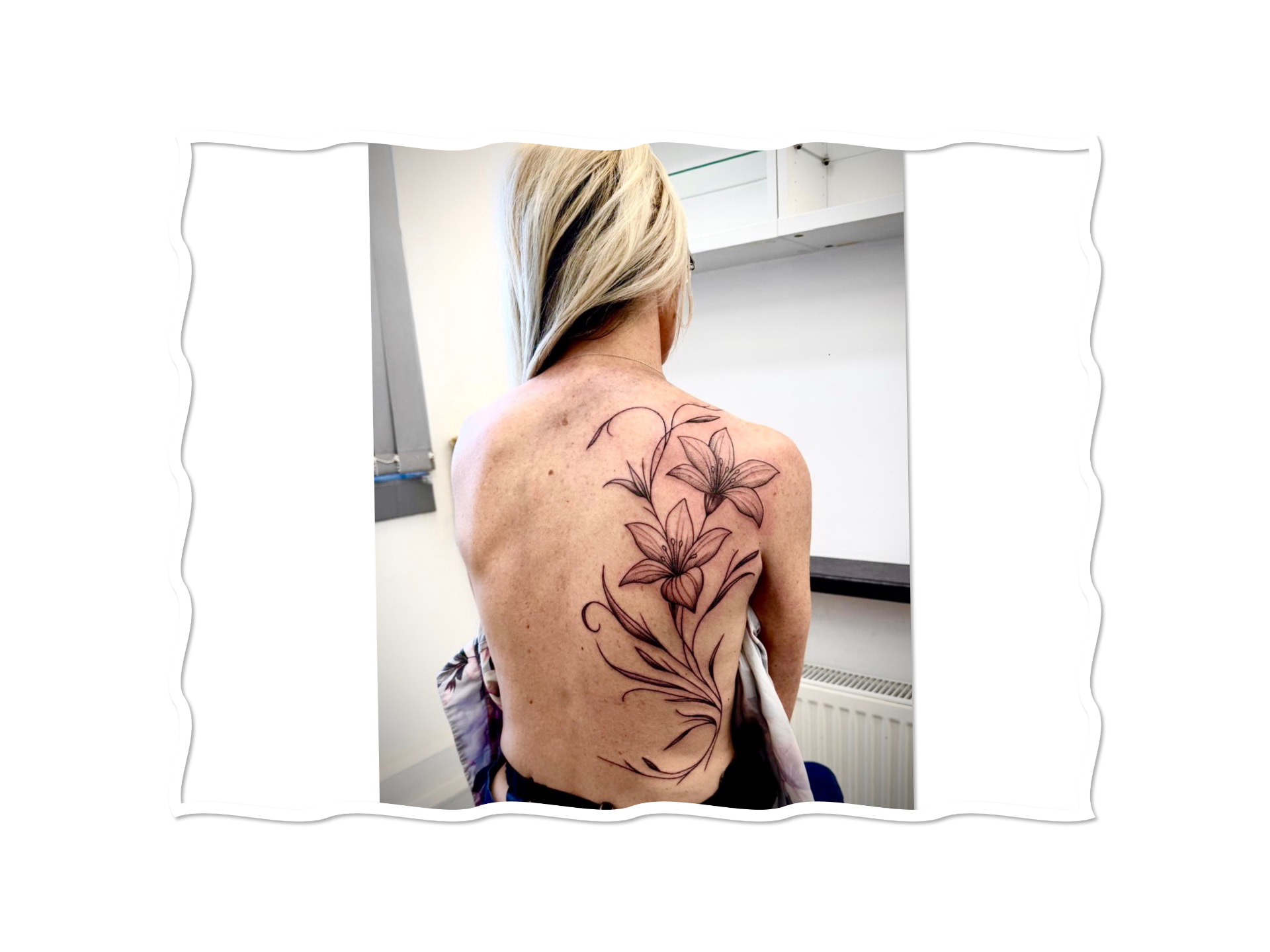Fine line lily back tattoo